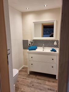 a bathroom with a white sink and a mirror at Ferienwohnung - a66157 in Leiwen