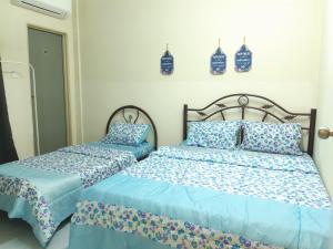 Postel nebo postele na pokoji v ubytování Ammar Homestay Gua Musang