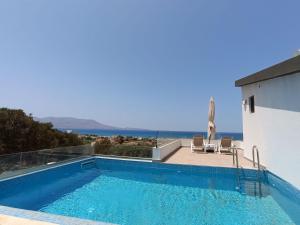 a swimming pool with a view of the ocean at Luxury Villas In Nopigia With A Private Pool - Isabel Artemis in Nopíyia
