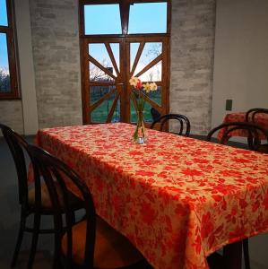 a table with a vase with a flower on it at CycloCamp & Hostel in Skorenovac