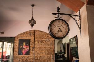 a clock hanging on the side of a wall at Hostel Backpackers in Mostar +40 photos