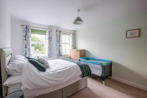 a small bedroom with a bed and a window at 4 Bedroom House in Addingham Ilkley in Addingham