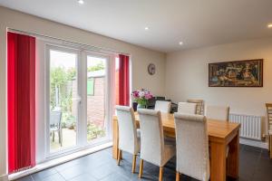 a dining room with a wooden table and chairs at 4 Bedroom House in Addingham Ilkley in Addingham
