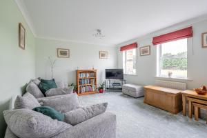 a living room with two couches and a tv at 4 Bedroom House in Addingham Ilkley in Addingham