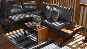 a living room with a couch and a table at Lucas Mobile Home - premium mobile home with terrace and patio in Drage