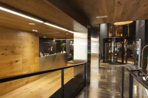 a lobby of a building with a person in the mirror at Zenit Vigo in Vigo