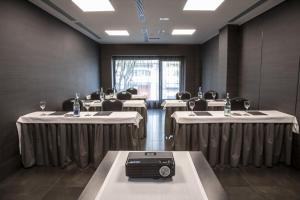 a dining room with tables and chairs and a room with tables at Zenit Vigo in Vigo