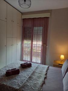 a bedroom with a large bed with two pillows on it at Evelins house Alexandroupoli in Alexandroupoli