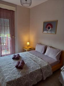 a bedroom with a large bed with two towels on it at Evelins house Alexandroupoli in Alexandroupoli
