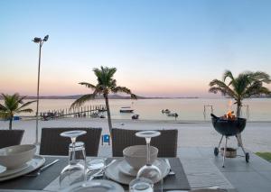 a dining table with a view of the beach at Bilene Lodge by Dream Resorts in Vila Praia Do Bilene +66 photos