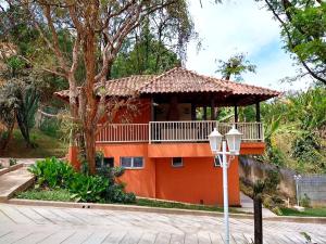 a house with a balcony on the side of it at VIA SPE - Pousada in Belo Horizonte