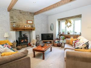 a living room with two couches and a fireplace at Ludd Brook Cottage in Halifax