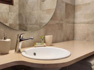 a bathroom with a sink and a mirror at Theodorou in Azolimnos Syros