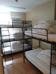 a group of bunk beds in a room at Bell House Hostel in London