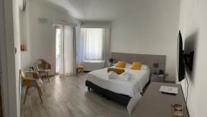 a hotel room with a bed and a desk and a television at Regia Hotel in Abbasanta +78 photos