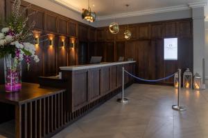 a lobby with a reception desk and a vase of flowers at Carrigaline Court Hotel & Leisure Centre in Cork
