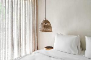 a bedroom with a bed and a pendant light at Hotel Anilevich Mansion in Beer Sheva
