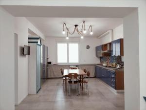 a kitchen with a table and a dining room at Appartamento Stella Marina in Senigallia
