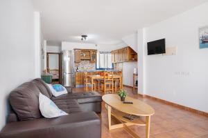 a living room with a couch and a table at Apartamento Callao, La Graciosa in Caleta de Sebo