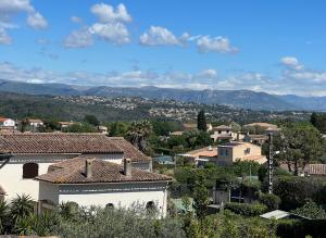 a city with houses and mountains in the background at Villa Constance - Antibes in Antibes