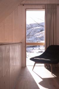 a room with a window and a bench in front of it at Eastside Woodshed - Pentland cabin set in the hills near Edinburgh in Penicuik