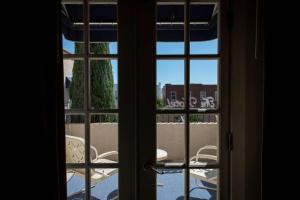 an open door with a view of a table and chairs outside at The Hotel Paisano in Marfa +15 photos