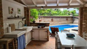 a kitchen with a sink and a table and a pool at Villa Amalia Apartment 2 in Malinska