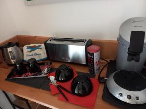 a counter top with a coffee maker and a toaster at Air de vacances in Clermont-lʼHérault