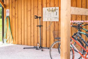 a bike parked next to a wooden wall with a sign at Residence Alessio in Ledro +117 photos