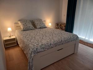 a bedroom with a bed with two pillows on it at Air de vacances in Clermont-lʼHérault