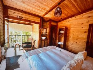 a bedroom with a bed in a wooden room at Calafate lodge patagonia in Coihaique