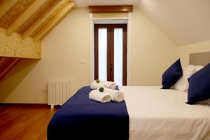 a bedroom with two beds with towels on it at Cabo do Mar Apart.- Baía Beach in Espinho