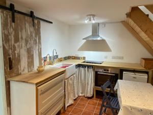 a kitchen with a sink and a counter top at The Soap Barn in Manorbier