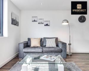 a living room with a couch and a coffee table at Luxe Modern Apartment By Your Perfect Stay Short Lets Birmingham in Birmingham