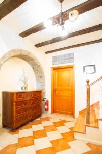 aoyer with a wooden door and a checkered floor at Apartments Villa Kastav in Kastav