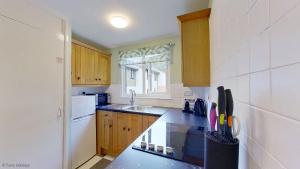 a kitchen with a sink and a counter top at 34 Strawberry Hill, Tolroy Manor in Hayle