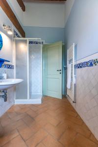 a bathroom with a shower and a sink and a door at Agriturismo I Savelli in Castiglione dʼOrcia +67 photos