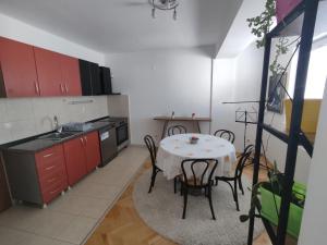 een keuken met een tafel en stoelen in een kamer bij Maja Apartment in Skopje