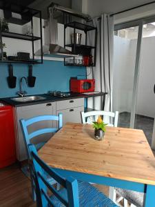 a kitchen with a wooden table and chairs in a kitchen at Jazz House in Solanas +34 photos