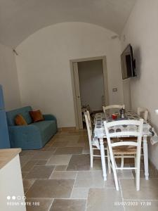 sala de estar con mesa, sillas y sofá en Villa Confalonieri, en Tricase
