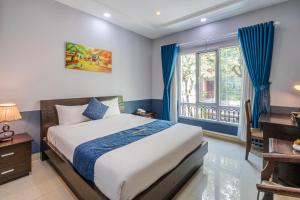 a bedroom with a large bed and a window at La Serena Hotel & Apartment in Ho Chi Minh City