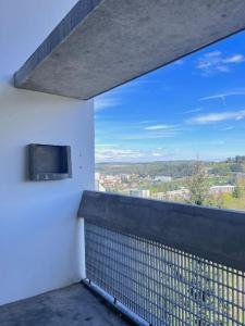 a balcony with a view of a city at Le Corbusier Expérience in Firminy