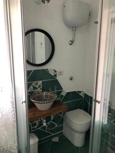 a bathroom with a toilet and a mirror at La Strettoia in Caprioli