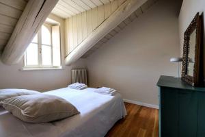 a bedroom with a large white bed and a window at Art Heaven-Suite Graneri in Torino Centro in Turin