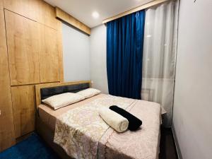 a bedroom with a bed with a pillow on it at City Center Cozy 3Bedroom Apartment with Unique Design and Hot Tub , 2Bathroom, Middle of Center, By Republic Square in Yerevan