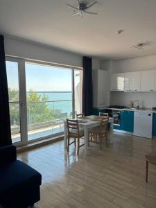 a kitchen and dining room with a table and chairs at Anda2 in Mamaia