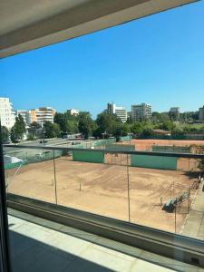 a view of a tennis court from a window at Anda2 in Mamaia