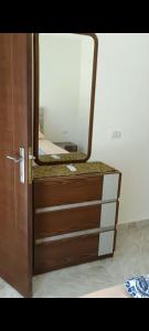 a dresser with a mirror on top of it at ميراج باى in Safaga