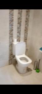 a bathroom with a white toilet in a room at ميراج باى in Safaga