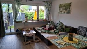 a little girl laying on a couch in a living room at Sandras Ferienhaus Bungalow Sonnenalm in Bad Mitterndorf